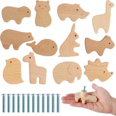 a hand holding a wooden cutout with different shapes and sizes of animals on it