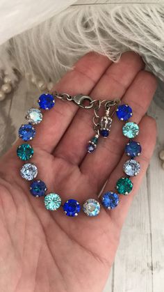 HUES OF BLUE - Genuine Austrian Crystal Tennis Bracelet.  This Bracelet holds an An eye catching arrangement of Royal and Cobalt Blue, Turquoise, Aquamarine, Navy and Teal -This varied mix of Round Stone Crystals in shades of blue will easily accessorize any 'Lover of Blues' Wardrobe!  DETAILS:  Genuine Austrian Crystal -8mm 7-8" adjustable  Lobster claw Clasp  Shown set in Nickel Free Antique Silver Finish. This listing is for the 8mm HUES OF BLUE Crystal tennis Bracelet only. The other Coordin Blue Aquamarine Bracelets For Gift, Blue Aquamarine Bracelets As Gift, Blue Aquamarine Bracelets As A Gift, Blue Aquamarine Bracelet For Gift, Blue Aquamarine Bracelet Perfect As A Gift, Adjustable Blue Aquamarine Bracelets, Nickel-free Blue Aquamarine Jewelry, Blue Nickel-free Crystal Bracelet For Gift, Blue Nickel-free Crystal Bracelet Gift