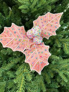 an ornament hanging from the top of a christmas tree with sprinkles