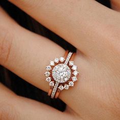 a woman's hand with a diamond ring on her finger and an engagement band