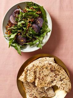 a plate of food next to a bowl of salad