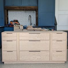 a kitchen with blue cabinets and drawers in it