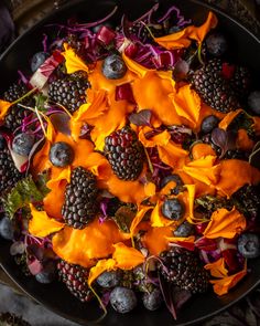 a bowl filled with fruit and vegetables on top of a table