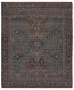 an antique rug with blue and brown colors