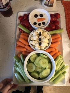 a snowman made out of carrots, celery and cucumbers