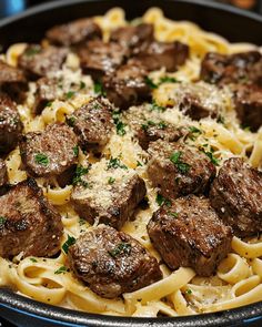 a close up of a plate of food with noodles and meatballs on it's side