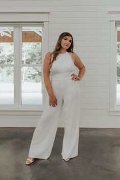 a woman in white jumpsuits posing for the camera