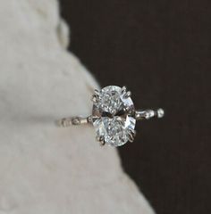 an engagement ring with two diamonds on it