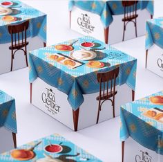 several boxes with different designs on them sitting side by side in the shape of chairs