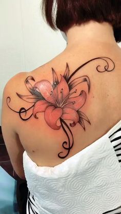 a woman with a flower tattoo on her shoulder