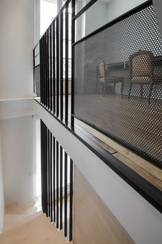 an empty room with chairs and railings on the wall in front of it is seen from above