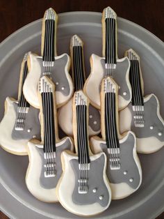 cookies decorated like guitars are on a plate