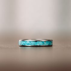 We designed this modern, yet elegant titanium and turquoise ring to commemorate the late American artist Georgia O'Keeffe. We sourced natural turquoise from The Sonoran desert to symbolize her immaculate collection of paintings of western landscapes. The O'Keeffe Titanium and Turquoise Ring Features: Lightweight, durable, and hypoallergenic titanium ring base Sky blue natural turquoise ring inlay Handcrafted in the USA by artisans Titanium Women's Ring We love crafting titanium rings for their d Georgia O Keeffe, Titanium Wedding Band, O Keeffe, Titanium Ring, Sonoran Desert, Sleeping Beauty Turquoise, Aqua Marine, Titanium Rings, Natural Aquamarine