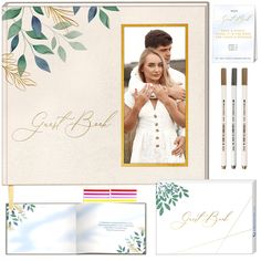 the wedding stationery is set up with two pens and an envelope, which has a photo on it