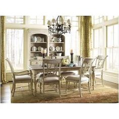 a dining room table with chairs and a chandelier