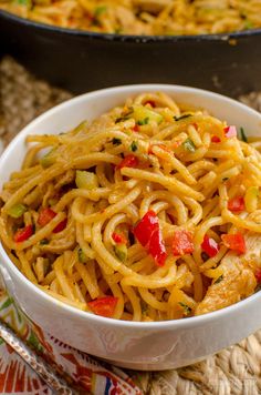 a white bowl filled with noodles and vegetables