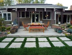 an outdoor patio with chairs and tables in the grass