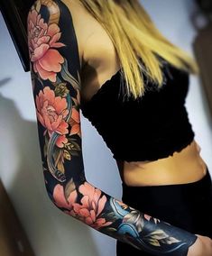 a woman with tattoos on her arms and arm