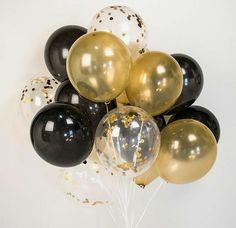 black, gold and white balloons with confetti on them against a white background