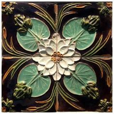 a decorative tile with flowers and leaves on it