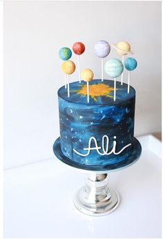 there is a cake with planets on it and the words all written in white letters