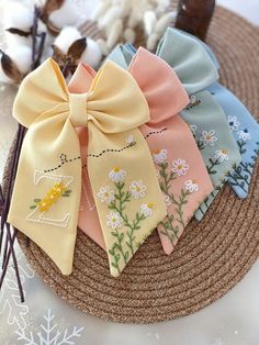 four bows are sitting on top of a straw hat with cotton flakes in the background