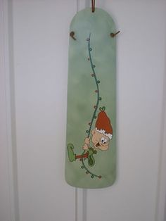 a green door hanger with a cartoon character on it's front and side