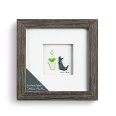 a framed picture with a cat and plant in it's shadow box, on a white background