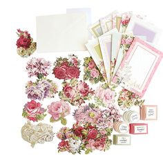 an assortment of flowers and cards on a white background