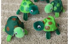 several green turtle toys on the floor