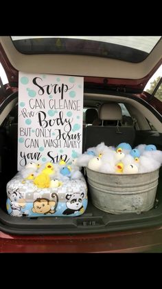 the back of a car with stuffed animals and soaps in it's trunk