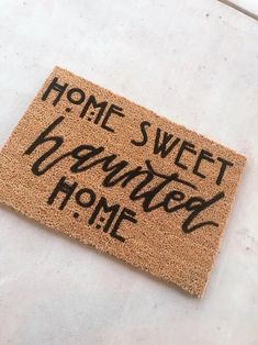 a door mat with the words home sweet and country home written in black on it