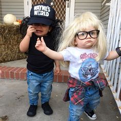 two young children dressed in costumes standing next to each other