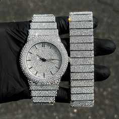 Step into elegance with this fully iced-out diamond watch and bracelet set that mirrors genuine luxury watches. We utilize premium simulated diamonds crafted from high-refractive crystals, ensuring a sparkle that rivals authentic diamonds under the light! INCLUDES AN EASY-TO-USE SIZE ADJUSTMENT TOOL Specifications: - Gender: Men's - Case Size: 46mm - Sizing: 8.5-inch band - Bracelet Length: 9-inches (Non-adjustable) - Movement: Quartz Movement - Battery: Included - Adjustable: Watch Links are re Iced Out Jewelry Men, White Gold Diamond Watch With Rhinestones, Iced Out Diamond Jewelry And Watches For Gifts, Luxury Stainless Steel Jewelry With Rhinestones, Luxury Rhinestone Stainless Steel Jewelry, White Gold Cubic Zirconia Bling Watch, Iced Out Diamond Watch As A Gift, Iced Out Diamond Watch As Gift, Silver Diamond Watch With Bling