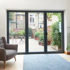 a living room with sliding glass doors leading to the back yard and patio area in front of it