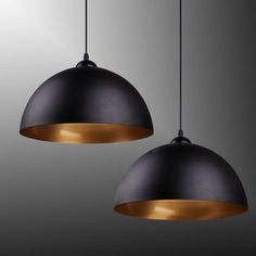 two black and gold lights hanging from the ceiling