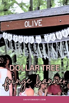 people standing under a dollar tree fringe banner with the words olive written on it in front of them