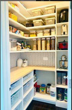 an organized pantry with white shelving and lots of food