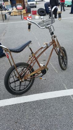 an old bicycle is parked in the parking lot