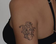 a woman with a snake tattoo on her shoulder