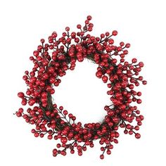 a wreath with red berries hanging from it