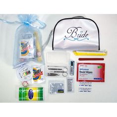 the contents of a travel kit laid out on a white surface with a blue bag