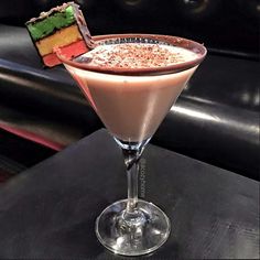 a chocolate martini with a slice of cake on the rim