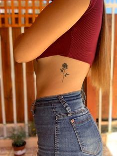 a woman with a rose tattoo on her stomach