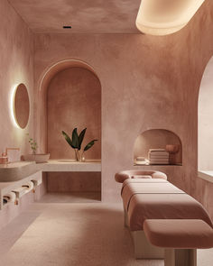 a spa room with pink walls and large mirrors on the wall, along with two massage tables