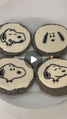 four cookies with white frosting decorated like dogs