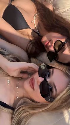 two beautiful young women laying next to each other