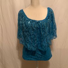 Ladies Teal Lace With Sequin Blouse Size Small. Fitted Blue Lace Top For Summer, Fitted Blue Lace Top Blouse, Blue Fitted Lace Top For Party, Bohemian Short Sleeve Party Tops, Bohemian Short Sleeve Tops For Party, Blue Summer Blouse For Night Out, Elegant Blue Lace Top For Summer, Elegant Light Blue Tops For Night Out, Elegant Light Blue Top For Night Out