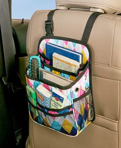 the back seat pocket is filled with cards, pens and pencils in it's holder