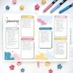 an open planner with stars on it and some markers next to it that says january